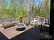 Relax on this spacious deck with plenty of seating and a built-in fire pit, surrounded by trees at 1496 Givens St, Hickory, NC 28602