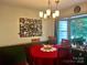 Cozy dining area with hardwood floors, chandelier lighting, wainscotting and a large bright window at 1496 Givens St, Hickory, NC 28602