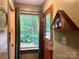 Charming entryway with a wood door, green curtains, and a view of the outside trees at 1496 Givens St, Hickory, NC 28602