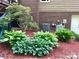 Well maintained exterior of home featuring colorful plants and brick and siding elements at 1496 Givens St, Hickory, NC 28602