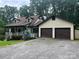 Charming two-story house with a welcoming front porch and a two-car garage, surrounded by lush greenery at 1496 Givens St, Hickory, NC 28602