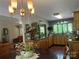 A dining table sits in the foreground to the bright kitchen with wood cabinets and a large window at 1496 Givens St, Hickory, NC 28602