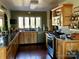A well-lit kitchen featuring wood cabinets, black countertops, and stainless steel appliances at 1496 Givens St, Hickory, NC 28602