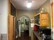 Kitchen leading to laundry area with stainless steel appliances and wood cabinetry at 1496 Givens St, Hickory, NC 28602