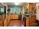 Spacious kitchen featuring light wood cabinetry, hardwood floors, stainless steel appliances, and a large window at 1496 Givens St, Hickory, NC 28602