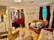 A eclectic living room area is furnished with unique seating options, including a hanging chair and wicker couch at 1496 Givens St, Hickory, NC 28602