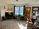 Cozy living room featuring a window, front door, wooden display cabinet, and a brown leather couch at 1496 Givens St, Hickory, NC 28602