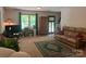 Spacious living room features a window, front door, and brown leather couch with an inviting area rug at 1496 Givens St, Hickory, NC 28602