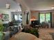 Comfortable living room showcases an arched doorway, breakfast bar, and a window with green curtains at 1496 Givens St, Hickory, NC 28602