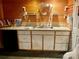 Wet bar with wooden planking, a sink, white cabinets and floating shelves for an organized beverage station at 1496 Givens St, Hickory, NC 28602