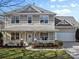 Charming two-story home with a welcoming front porch and manicured lawn, perfect for curb appeal at 2003 Savoy Ct, Indian Trail, NC 28079