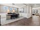 Formal dining area with modern lighting, wainscoting, and an adjacent living space at 3009 Tramore Dr, Harrisburg, NC 28075