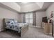 This bright bedroom features plush carpeting, a tray ceiling, and a large window for ample sunlight at 3019 Foggy Hollow Ln, Clover, SC 29710