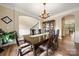 Elegant dining room with dark wood table, crown molding, and view of the staircase at 3019 Foggy Hollow Ln, Clover, SC 29710