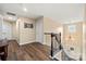 This hallway features hardwood floors, neutral walls, black iron railings, and an elegant chandelier at 3019 Foggy Hollow Ln, Clover, SC 29710