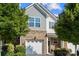 Exterior view of a brick townhome with grey siding, blue skies and healthy green landscaping at 3306 Yarmouth Ln, Gastonia, NC 28056