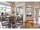 Bright dining area with large windows, hardwood floors, and a modern chandelier above the table at 407 Newstyle Way # 2, Cramerton, NC 28056