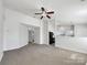 Open living room with ceiling fan and view of eat-in kitchen at 4427 Wills Way, Charlotte, NC 28227