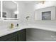 Bright bathroom with a vanity, LED mirror, long countertop, and updated fixtures at 4913 Seacroft Rd, Charlotte, NC 28210
