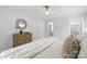 A bedroom with a dresser, decorative mirror, and doorway to closet space at 4913 Seacroft Rd, Charlotte, NC 28210
