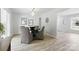 Elegant dining room with modern light fixture, neutral paint, and backyard views at 4913 Seacroft Rd, Charlotte, NC 28210