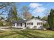 Charming single-story home with a well-manicured lawn, mature trees, and a cozy, inviting entrance at 4913 Seacroft Rd, Charlotte, NC 28210