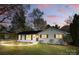 Charming, single-story home with white painted brick, dark shutters, well-maintained lawn, and walkway lighting at 4913 Seacroft Rd, Charlotte, NC 28210
