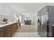 Kitchen with stainless steel appliances opening to dining room with table and gray cushioned chairs at 4913 Seacroft Rd, Charlotte, NC 28210
