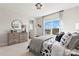 Bedroom features a large window, a bed with unique patterned bedding, and football-themed decorations at 5009 Duval Cir, Tega Cay, SC 29708