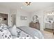 Charming bedroom featuring a neutral color palette, sporty bedding, and doorway to en suite bathroom at 5009 Duval Cir, Tega Cay, SC 29708