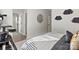 Stylish bedroom with black and white bedding, a cat tree, and view to en suite bathroom at 5009 Duval Cir, Tega Cay, SC 29708