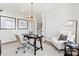 Well-lit home office includes modern decor, a desk, chair, and a comfortable reading area at 5009 Duval Cir, Tega Cay, SC 29708