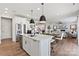 Open-concept living space with kitchen island, adjacent to dining area and living room at 5009 Duval Cir, Tega Cay, SC 29708