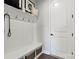 Welcoming mudroom featuring white paneled walls, coat hooks, and a storage bench with baskets at 5009 Duval Cir, Tega Cay, SC 29708