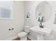 Elegant powder room with a pedestal sink, toilet, and modern fixtures at 5009 Duval Cir, Tega Cay, SC 29708