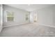 Inviting bedroom features plush carpeting, two bright windows, and an ensuite bathroom that provides privacy at 5013 Duval Cir, Tega Cay, SC 29708