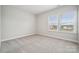 An empty room with neutral carpeting and lots of natural light at 5013 Duval Cir, Tega Cay, SC 29708