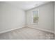Neutral bedroom features plush carpeting, white walls and natural light to create a tranquil, relaxing retreat at 5013 Duval Cir, Tega Cay, SC 29708