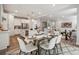 Open-concept dining area with a glass-top table, modern seating, and bright, airy atmosphere at 5013 Duval Cir, Tega Cay, SC 29708