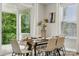 Bright dining area with glass table, modern decor, and outdoor views at 5013 Duval Cir, Tega Cay, SC 29708
