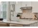 Close up on gourmet kitchen island with stainless steel faucet, modern appliances and backsplash at 5013 Duval Cir, Tega Cay, SC 29708