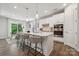 Bright kitchen featuring a large island, stainless steel appliances, and modern pendant lighting at 5013 Duval Cir, Tega Cay, SC 29708