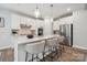Modern kitchen showcasing a large island with barstool seating and stainless steel appliances at 5013 Duval Cir, Tega Cay, SC 29708