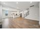 Open-concept living space with wood floors, kitchen island, and natural light at 5013 Duval Cir, Tega Cay, SC 29708
