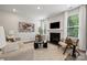 Cozy living room featuring a fireplace, modern decor, and natural light at 5013 Duval Cir, Tega Cay, SC 29708