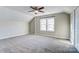 Carpeted bedroom with neutral walls, a ceiling fan, and a large window at 508 N Hill St, Dallas, NC 28034