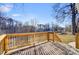 The wooden deck has railings and overlooks a grassy yard with mature trees, perfect for outdoor entertaining at 508 N Hill St, Dallas, NC 28034