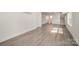 Finished basement with gray flooring and a door to an unfinished area at 523 Belmorrow Dr, Charlotte, NC 28214