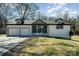 Charming single-story home with white brick, dormer windows, and a two-car garage at 523 Belmorrow Dr, Charlotte, NC 28214