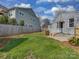 Lush backyard with green grass and a view of the home's exterior at 5300 Buckingham Dr, Charlotte, NC 28209